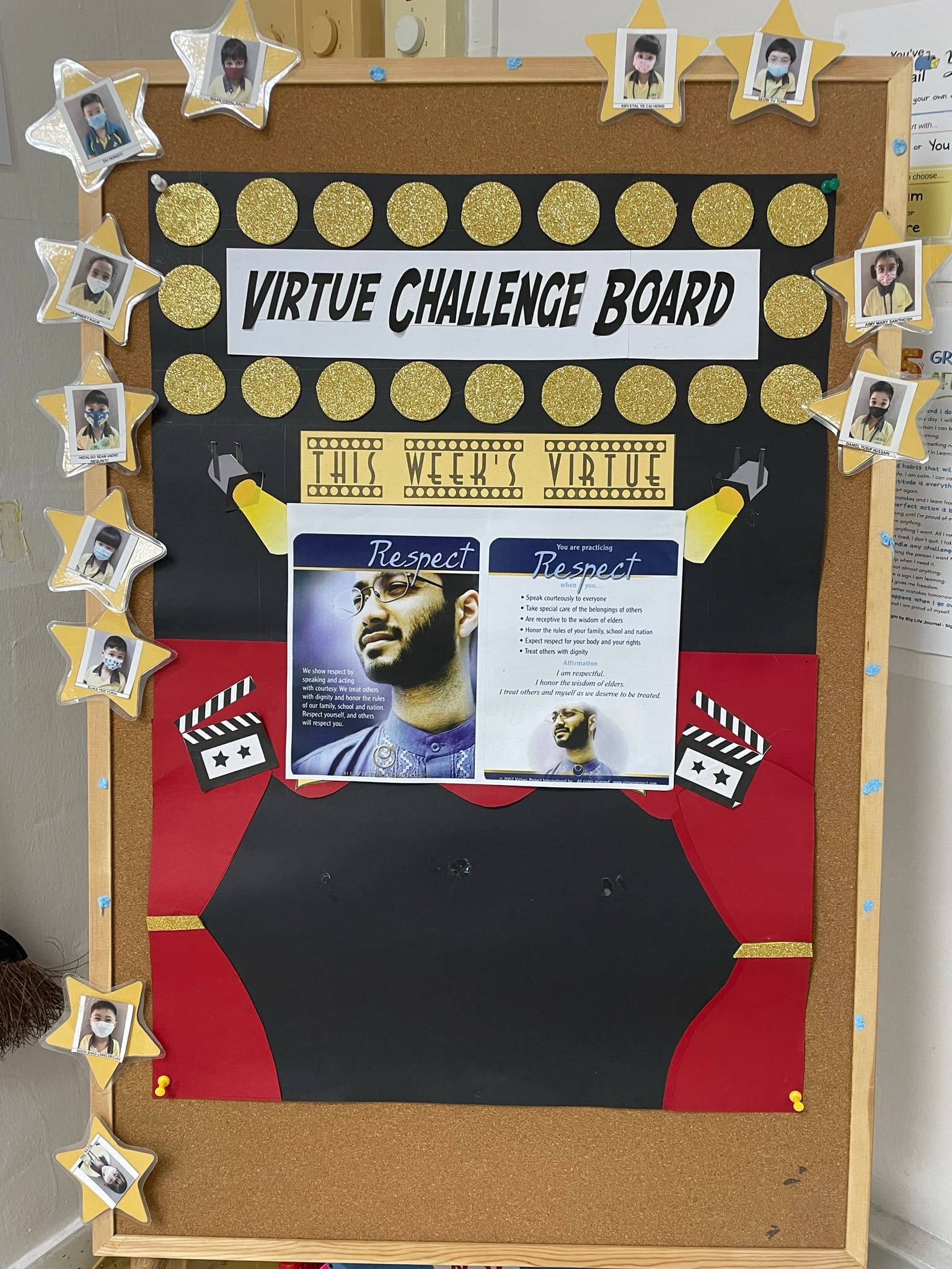 Classroom bulletin board titled Virtue Challenge Board featuring this week's virtue Respect, decorated with gold stars and student photos.